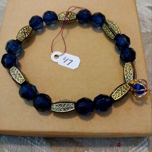 Artemis's Gems custom-made beaded bracelet with metal flower beads, blue/gold